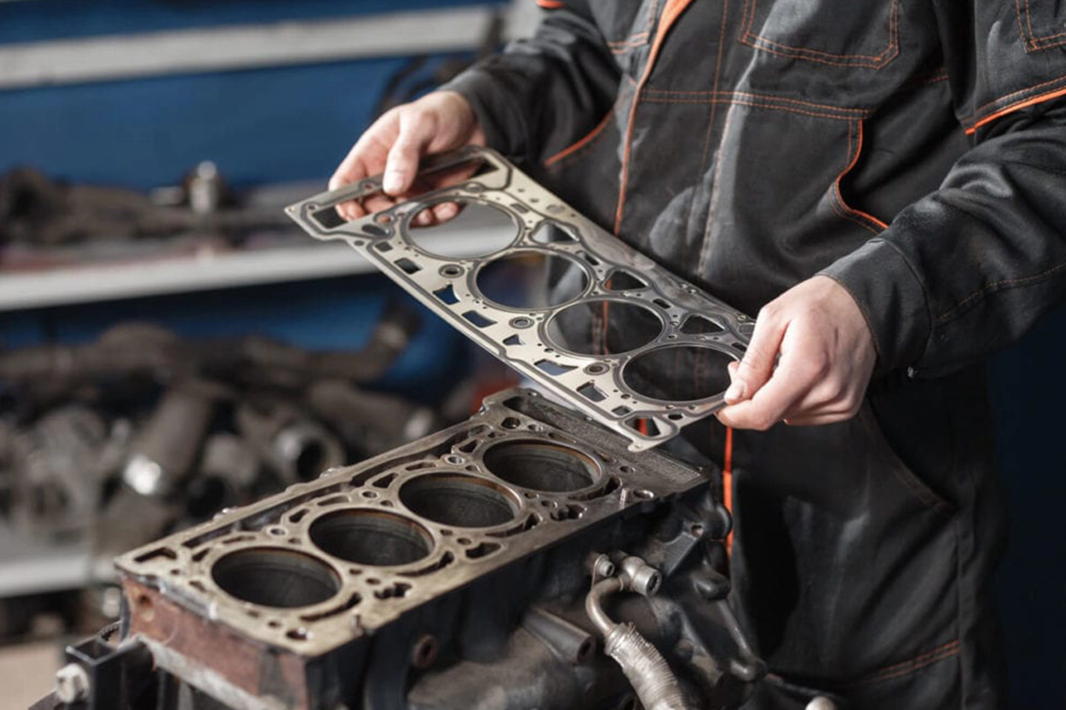 head gasket being inspected by mechanic